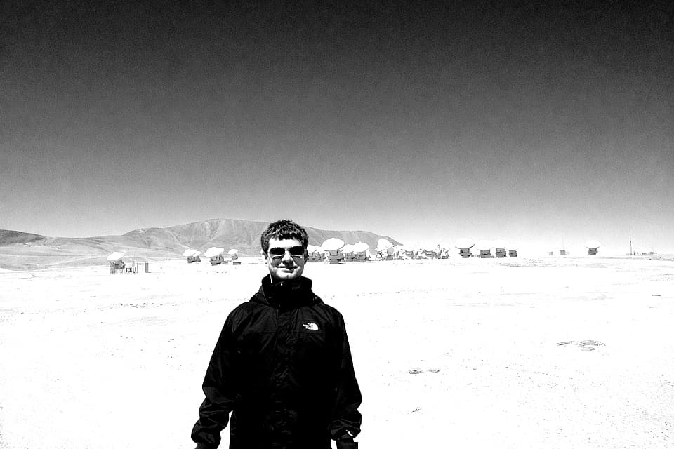 Black-and-white photo in a wide desert landscape.